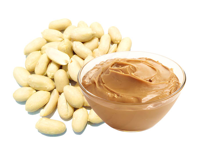 Why should peanuts be peeled before grinding peanut butter?